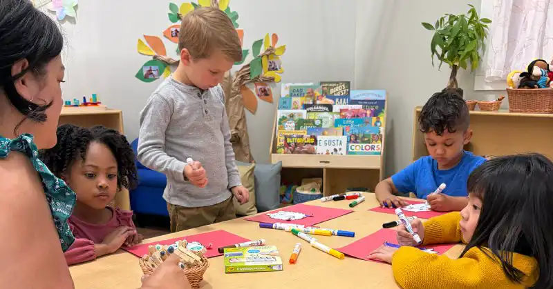 Preschool teacher leading a hands-on learning activity